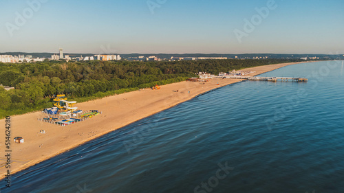View of the beach and pier in Brzeźno, Gdańsk at sunrise. Summer 2022.