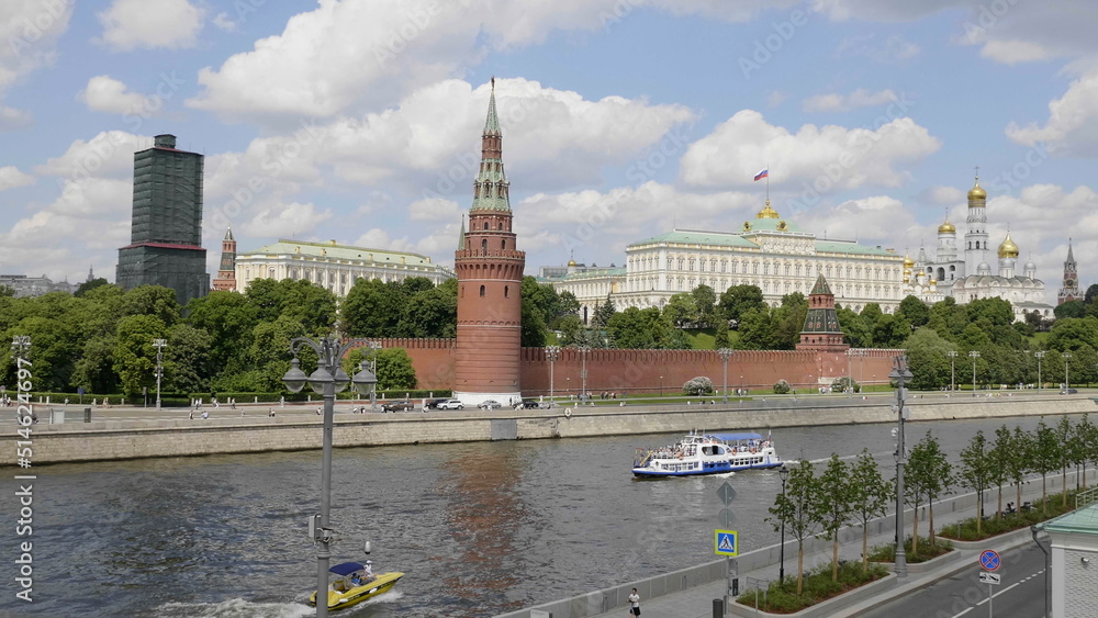 Obraz premium MOSCOW, RUSSIA - MAY 22, 2022: View of the Moscow Kremlin from the Moscow river. Red brick towers and Bell Tower Of Ivan The Great