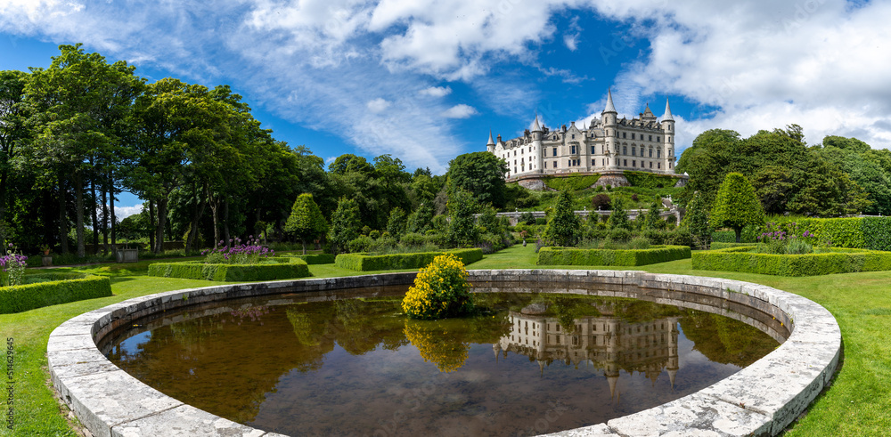 view of Dunrobin Castle and Gardens in the Scottish Highlands and castle reflection in the fountain view of Dunrobin Castle and Gardens in the Scottish Highlands and castle reflection in the fountain