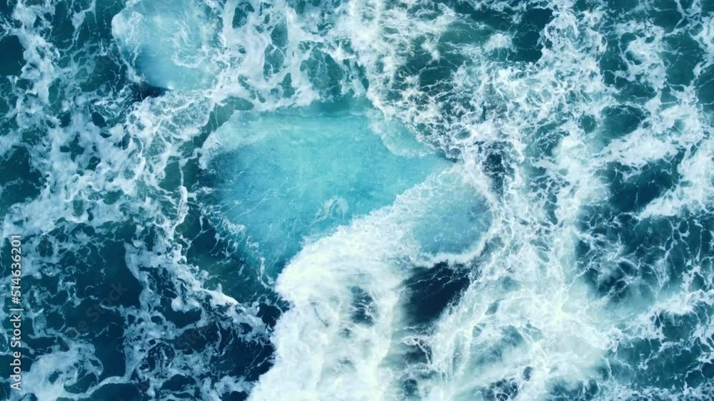 Iceberg huge chunks of blue Ice floating on the waves in the ocean beautiful arctic landscape aerial top view Iceberg huge chunks of blue Ice floating on the waves in the ocean beautiful arctic landscape aerial top view