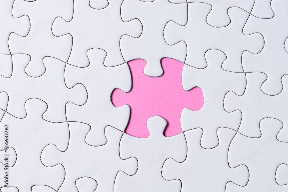 Piece of jigsaw puzzle on pink paper. Flat lay, Directly above. Piece of jigsaw puzzle on pink paper. Flat lay, Directly above.