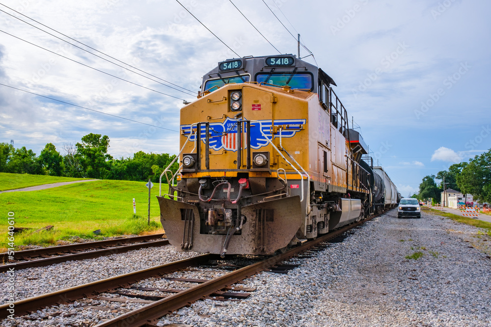Union Pacific Railroad Locomotive Passes A Pickup Truck Between The 