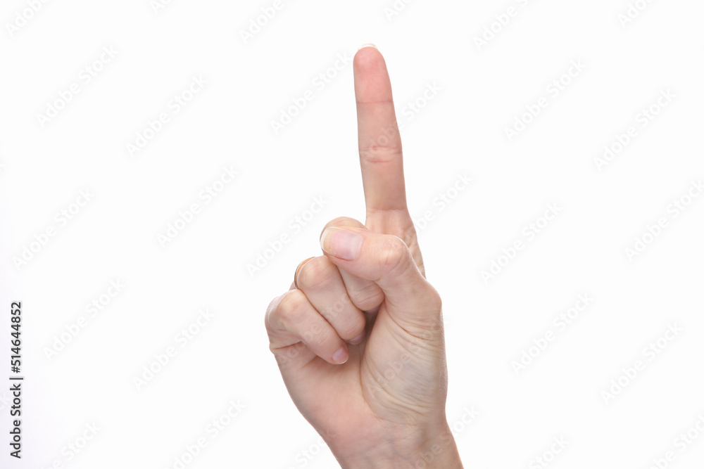 Female hand shows one finger isolated on white background. Female hand shows one finger isolated on white background.