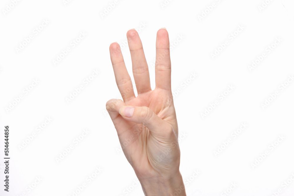 Female hand shows three fingers isolated on white background. Female hand shows three fingers isolated on white background.