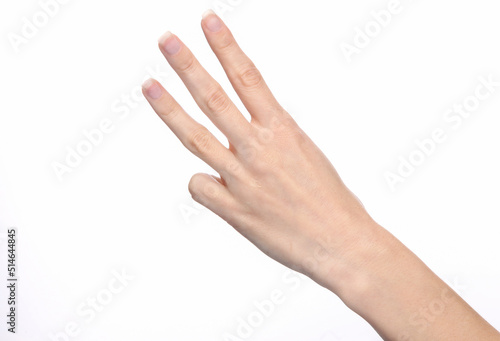 Female hand shows three fingers isolated on white background.