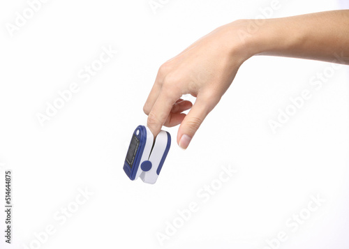 Hand finger with pulse oximeter clip isolated on white background. Measure the saturation of hemoglobin with oxygen in arterial capillary blood.