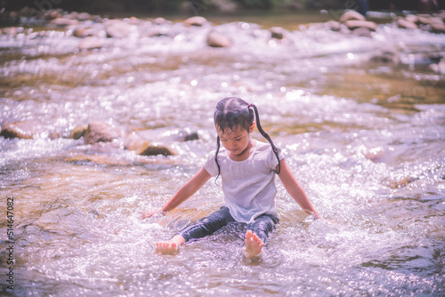 girls having fun playing in the waterfall