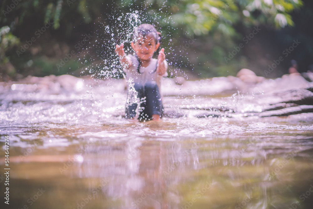 Fototapeta premium girls having fun playing in the waterfall