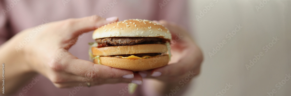 Woman going to eat cheeseburger Woman going to eat cheeseburger