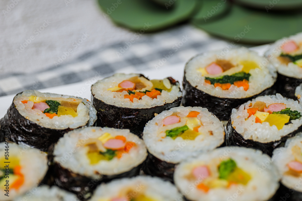 Korean food Gimbap : Rice seasoned with salt and sesame oil and rolled up in a sheet of roasted gim (dried laver) with spinach, carrots, and pickled white radish. The long roll is sliced and served in Korean food Gimbap : Rice seasoned with salt and sesame oil and rolled up in a sheet of roasted gim (dried laver) with spinach, carrots, and pickled white radish. The long roll is sliced and served in