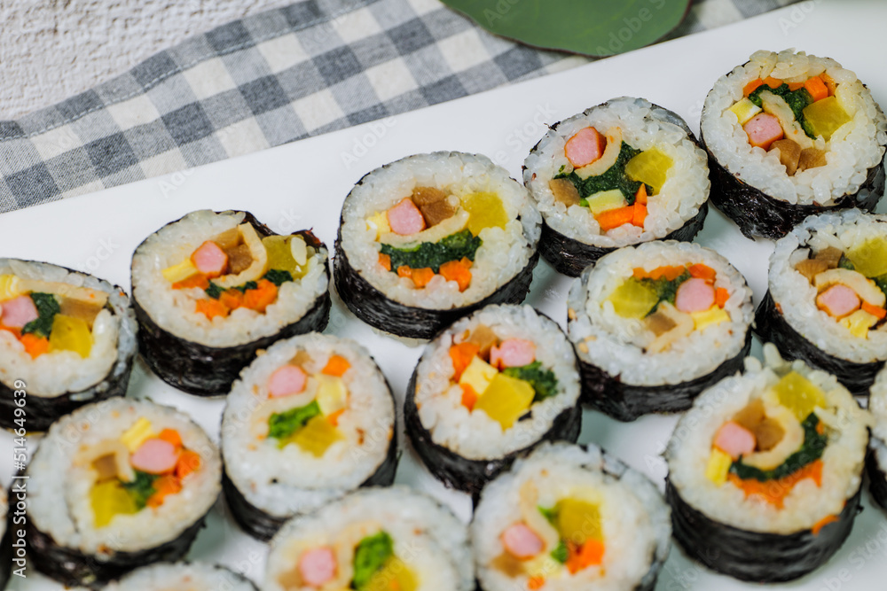 Korean food Gimbap : Rice seasoned with salt and sesame oil and rolled up in a sheet of roasted gim (dried laver) with spinach, carrots, and pickled white radish. The long roll is sliced and served in Korean food Gimbap : Rice seasoned with salt and sesame oil and rolled up in a sheet of roasted gim (dried laver) with spinach, carrots, and pickled white radish. The long roll is sliced and served in