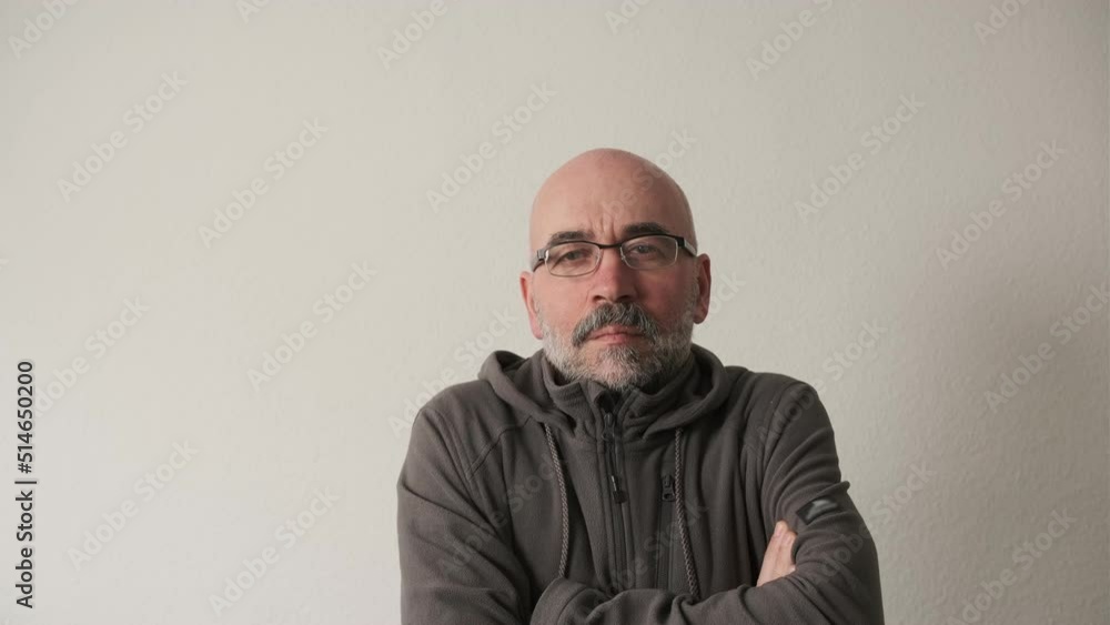 Bearded man in a cap on a white background in the studio looking at the camera Bearded man in a cap on a white background in the studio looking at the camera