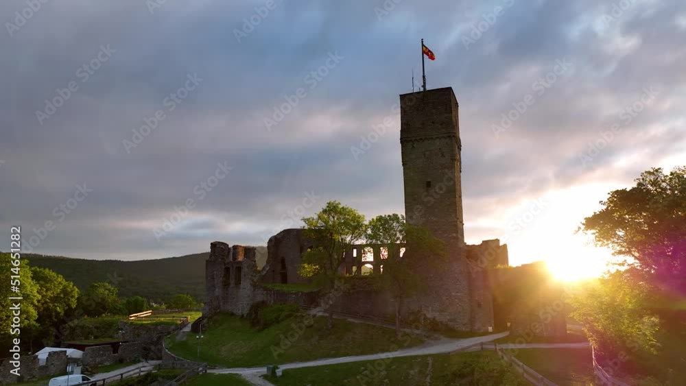 Castle Königstein on a Hill, State of Hesse, Germany. European castle, fortress ruin from above with aerial drone shot in backlight. Beautiful landscape with old castle ruins on mountain Castle Königstein on a Hill, State of Hesse, Germany. European castle, fortress ruin from above with aerial drone shot in backlight. Beautiful landscape with old castle ruins on mountain