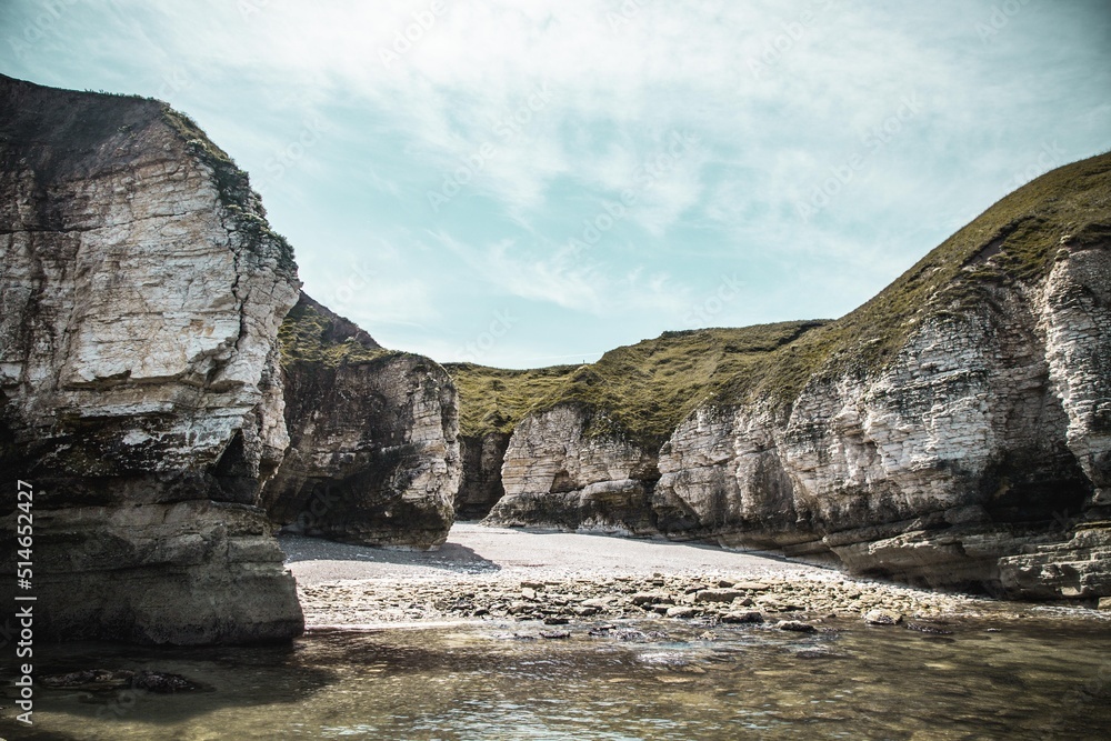 White grassy rocks in the deep blue sea