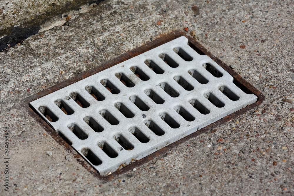 Storm sewer grate in the sidewalk Storm sewer grate in the sidewalk