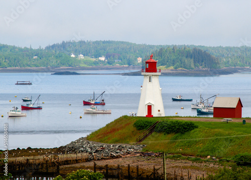 lighthouse with boats