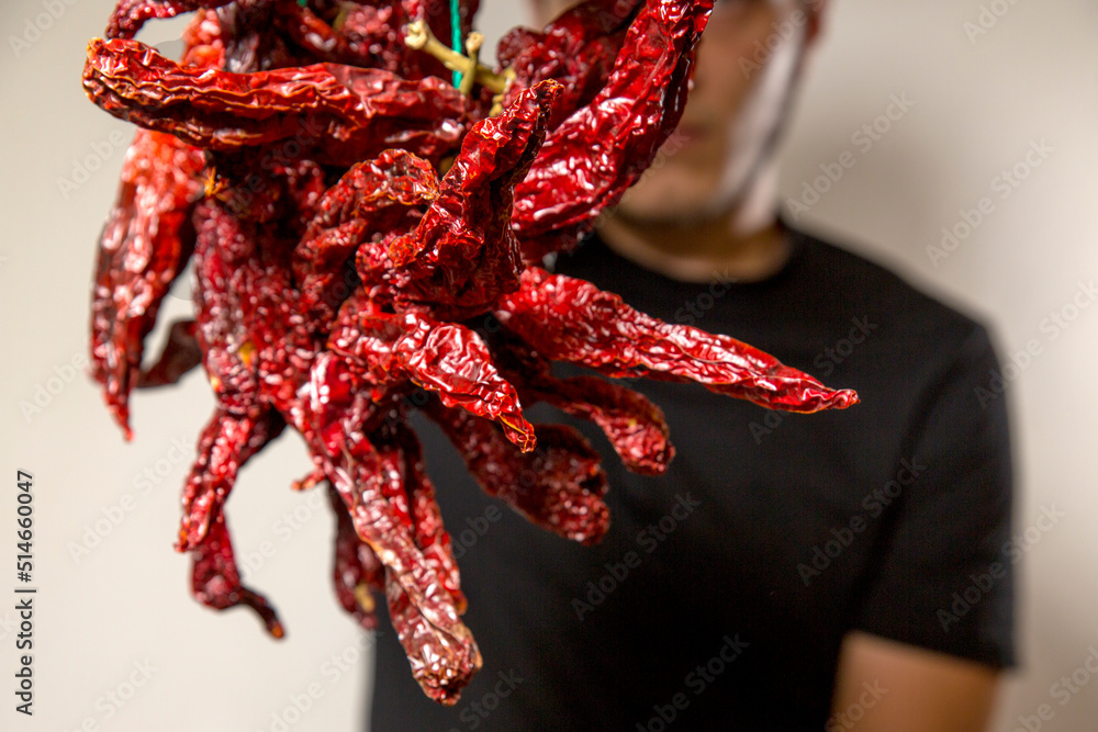 Closeup of peperoni cruschi, an air-dried crunchy sweet pepper used in the cuisine of Basilicata in Italy. Typical product of Lucan cuisine on white background. Closeup of peperoni cruschi, an air-dried crunchy sweet pepper used in the cuisine of Basilicata in Italy. Typical product of Lucan cuisine on white background.