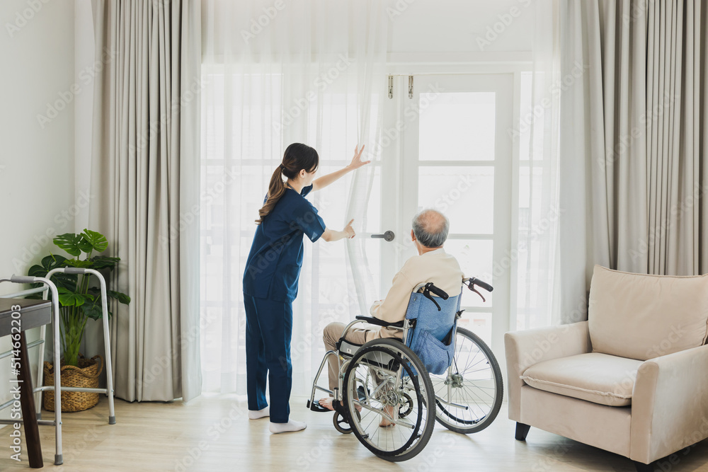 Senior Asian man in wheelchair receives medical help for injury, take care and take to looking looking out of window Senior Asian man in wheelchair receives medical help for injury, take care and take to looking looking out of window