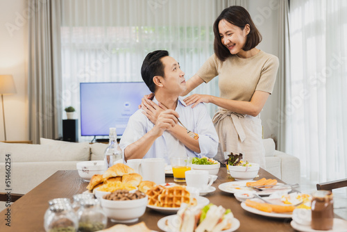 Asian wife talk with husband in breakfast  Happy family talking before going out to work