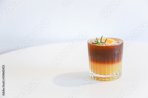 Orange americano coffee on table and white background for design