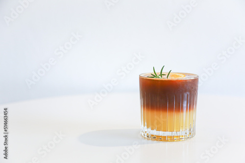 Orange americano coffee on table and white background for design