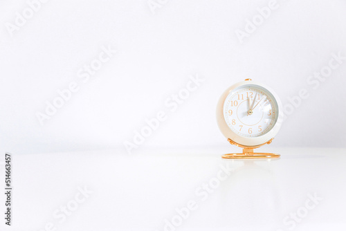 rose gold clock on white table and white background for design