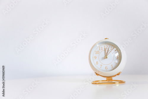 rose gold clock on white table and white background for design
