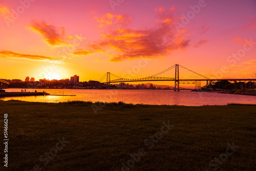 Hercilio luz cable bridge with bright sunset and reflection on water in Florianopolis