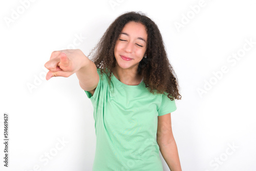 Wallpaper Mural Teenager girl with afro hairstyle wearing green T-shirt over white wall pointing displeased and frustrated to the camera, angry and furious ready to fight with you. Torontodigital.ca