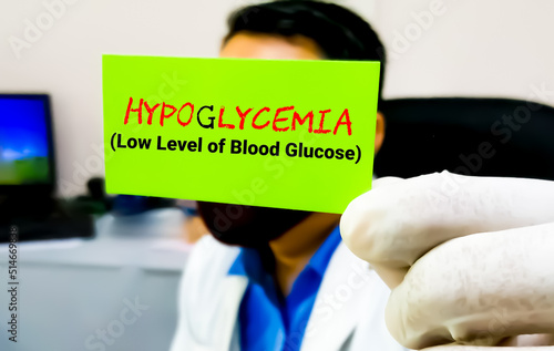 Hypoglycemia, medical term. Scientist hold card with text Hypoglycemia.