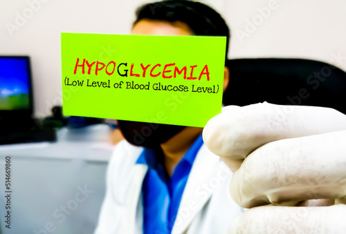 Hypoglycemia, medical term. Scientist hold card with text Hypoglycemia. photo