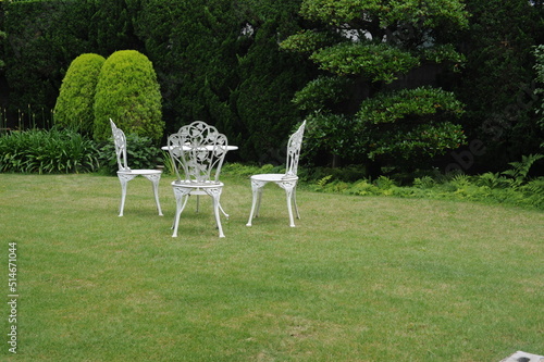 white chairs and table in the garden