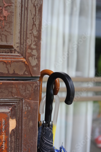  umbrellas leaning against old weathered wooden door