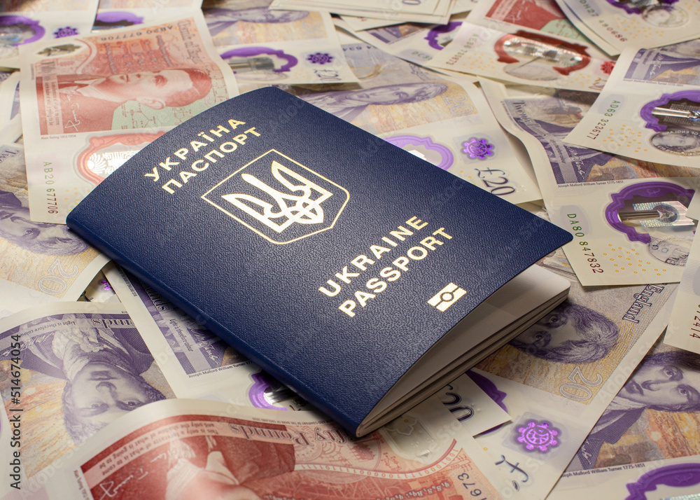 passport of ukraine on the background of english pounds, war in ukraine migration to england. passport of ukraine on the background of english pounds, war in ukraine migration to england.