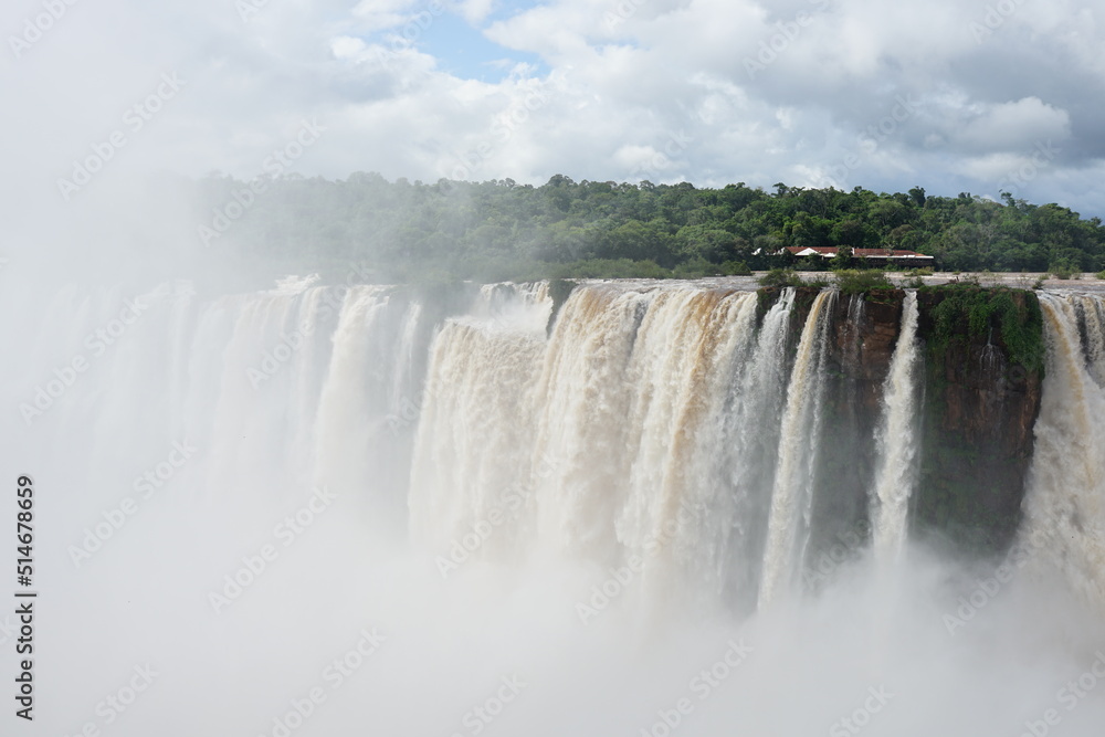 The photo shows a stunning view from the top of the Iguazu Falls — a complex of 275 waterfalls on the Iguazu River, located on the border of Brazil and Argentina The photo shows a stunning view from the top of the Iguazu Falls — a complex of 275 waterfalls on the Iguazu River, located on the border of Brazil and Argentina