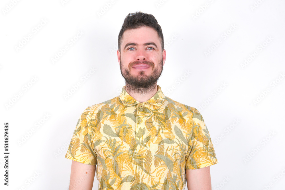 Happy Young caucasian man wearing Hawaiian t-shirt over white background looking at camera with charming cute smile. Happy Young caucasian man wearing Hawaiian t-shirt over white background looking at camera with charming cute smile.