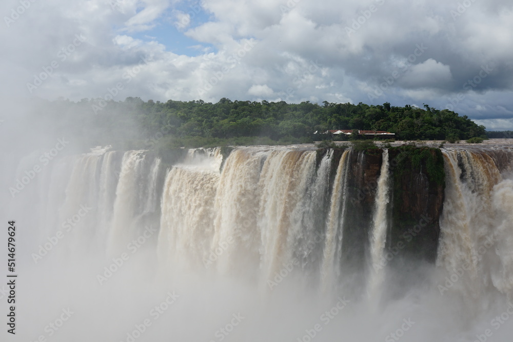 The photo shows a stunning view from the top of the Iguazu Falls — a complex of 275 waterfalls on the Iguazu River, located on the border of Brazil and Argentina The photo shows a stunning view from the top of the Iguazu Falls — a complex of 275 waterfalls on the Iguazu River, located on the border of Brazil and Argentina