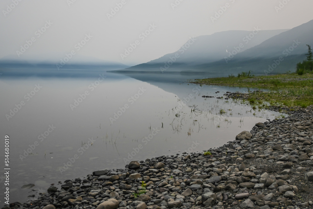 A mountain lake in a misty haze.