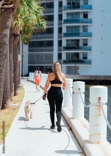 woman walking with dog beautiful scene lifestyle miami Brickell sport running morning 