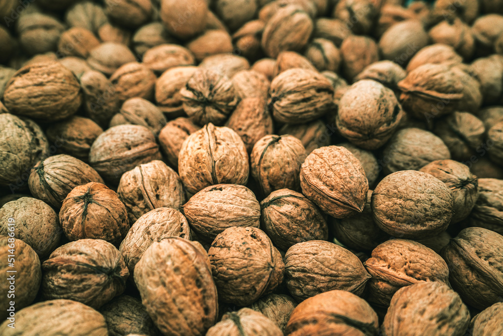 Walnuts with shell (filling the picture). Background of fresh nuts