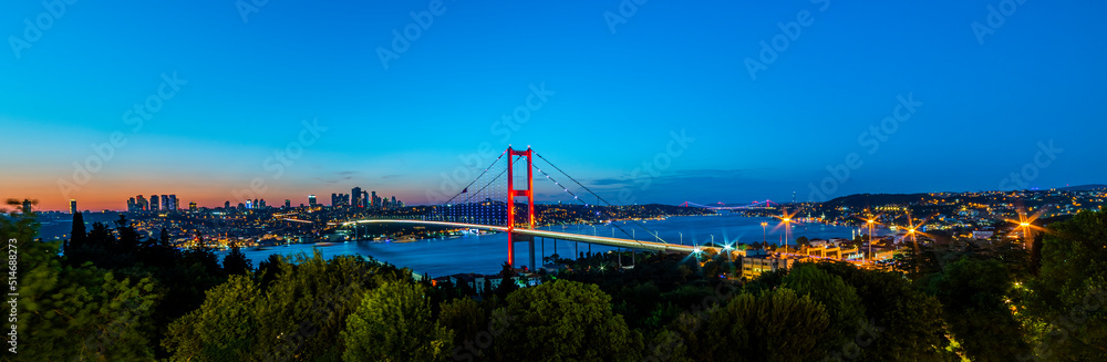 Naklejka premium ISTANBUL, TURKEY. Panoramic view of Istanbul Bosphorus on sunset. Istanbul Bosphorus Bridge (15 July Martyrs Bridge. Turkish: 15 Temmuz Sehitler Koprusu). Beautiful cloudy blue sky.