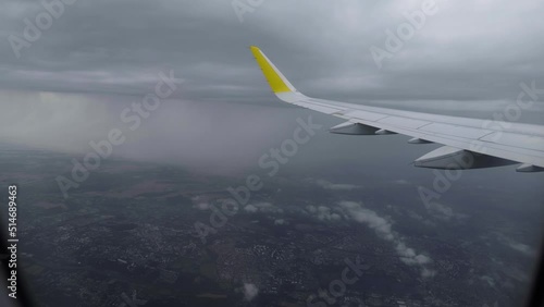 View from in side plane cabin through plane window while storm raining outside. Airplane flying steadily through a severe lightning storm. Spectacular thunderstorm as seen from the front plane window. photo