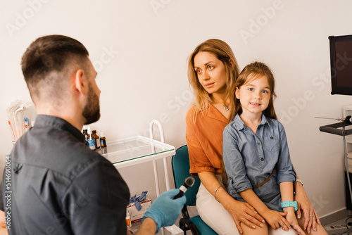 Woman and her child daughter visit ENT doctor. Consultation about endoscopy of nose for family with otolaryngologist in a medical clinic.