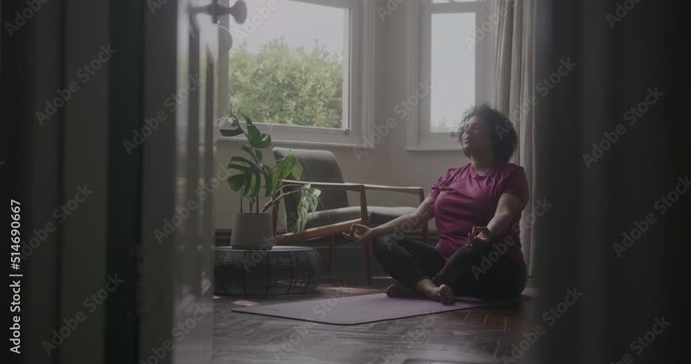 Active Mature Adult Woman Exercising Yoga at Home Active Mature Adult Woman Exercising Yoga at Home