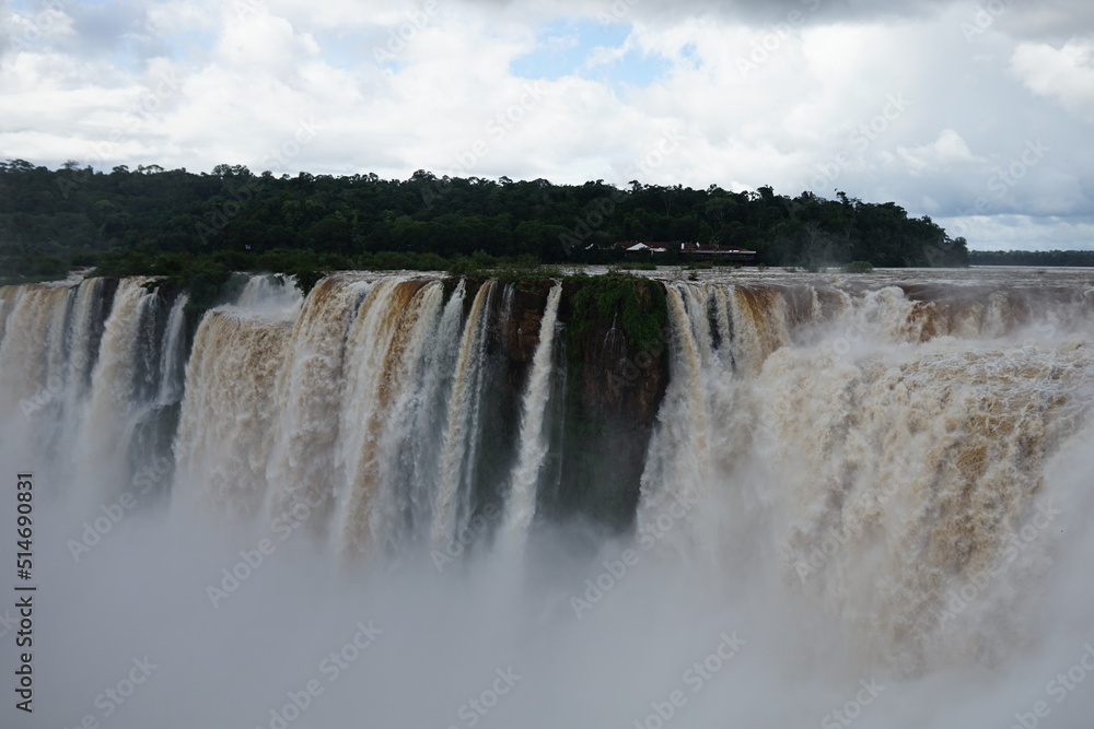 The photo shows a stunning view from the top of the Iguazu Falls — a complex of 275 waterfalls on the Iguazu River, located on the border of Brazil and Argentina The photo shows a stunning view from the top of the Iguazu Falls — a complex of 275 waterfalls on the Iguazu River, located on the border of Brazil and Argentina