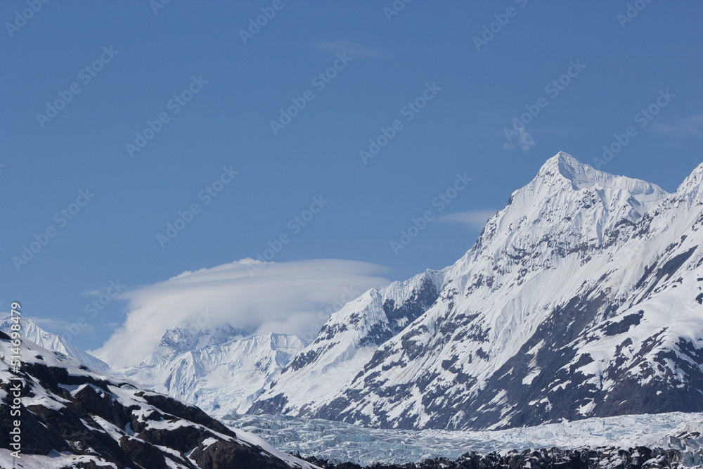 Orbital cloud formation (lenticular clouds) around an Alaskan mountain range with peak