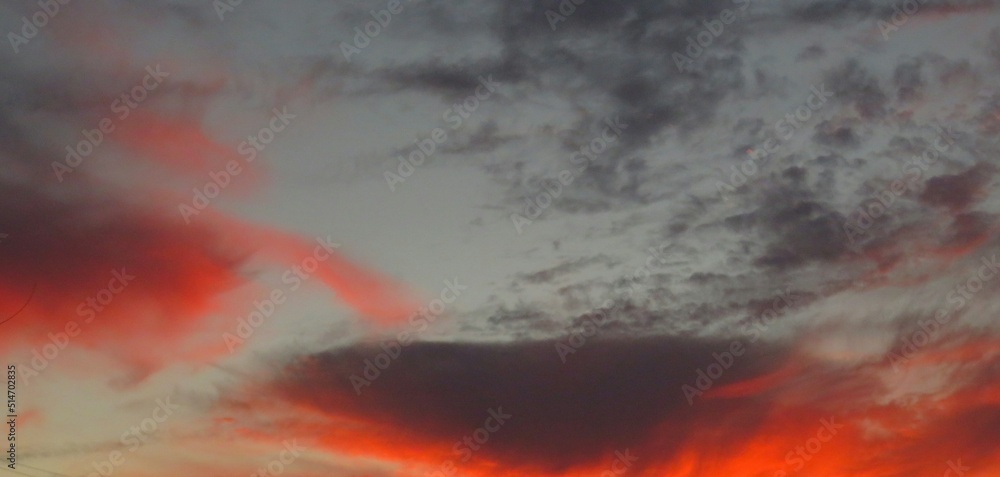 Panoramic view on fiery sunset on the sky