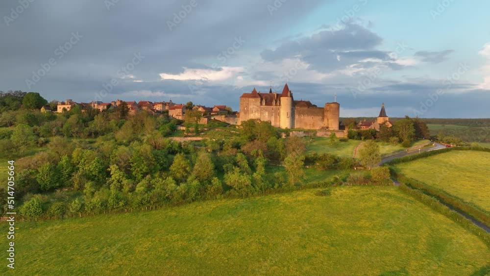 Aerial view of Châteauneuf-en-Auxois castle and medieval village one of the most beautiful villages of France with colorful sunset sky Aerial view of Châteauneuf-en-Auxois castle and medieval village one of the most beautiful villages of France with colorful sunset sky
