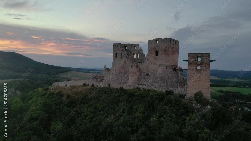 Aerial view of ruined Gothic Csesznek castle in the Bakony region of Hungary in Veszprem county with old palace building, gate tower with colorful dramatic sunset Aerial view of ruined Gothic Csesznek castle in the Bakony region of Hungary in Veszprem county with old palace building, gate tower with colorful dramatic sunset