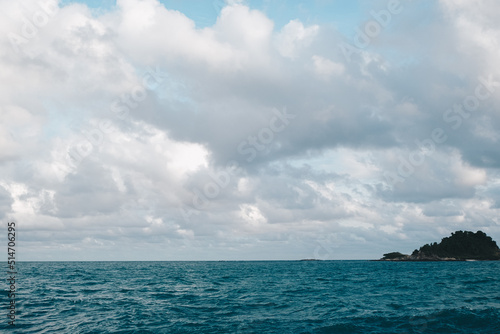 Sea coast rocky beach sunset light with blue sky cloud